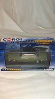 Front view of the boxed die cast Jaguar model car inside the plastic case with clear Corgi branding and collector card visible