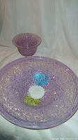 Two pink speckled glass bowls, larger bowl about 10 inches with green and blue areas and smaller bowl about 5 inches
