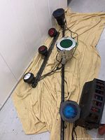 Wide view of the DJ lighting system laid out on a cloth showing multiple lighting units and poles.