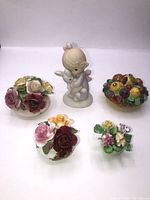 Photo shows three bone china flower bouquets, the ceramic trinket box with floral roses, and the Jonathan David angel holding a rabbit figurine on white background.