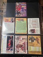 Top row of trading card sleeve with front and back views of several Michael Jordan cards