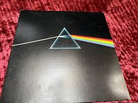 Front cover of Pink Floyd Dark Side of the Moon album featuring prism and rainbow light artwork.