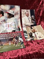 Four 49ers-related photos laid against a red fabric, showing Joe Montana, Roger Craig, Jerry Rice, and Taylor in various poses including game action and Hall of Fame ceremonies.