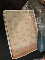 Closed box lined with paper showing ECS branding possibly containing some of the items