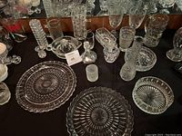Top-down view of the collection showing crystal glassware and serving items arranged on a table.