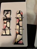 Black and white ghost-themed watch band with cartoon designs on a white surface