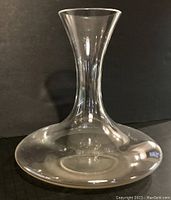 Clear glass Riedel wine carafe viewed from front showing shape and size.