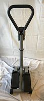 Front view of Cardio Style ST100 stair climber showing triangular handlebar and foot pedals