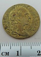 Front side of the 1788 Great Britain gold plated game token showing a right-facing male profile with laurel.