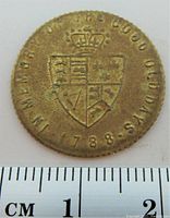 Obverse side with crowned heraldic shield, inscription 'IN MEMORIAM OF THE GOOD OLD DAYS 1788',' measured against a ruler showing approximately 22mm diameter.
