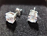 Close-up view of the two round cubic zirconia stones in sterling silver prong settings, showing clarity and faceting.