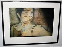 Frontal close-up of framed abstract art print featuring a man with textured overlay and Asian characters.