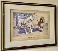 Framed art print hanging on wall depicting two white Bull Terriers and a brown Poodle with a bow, signed by C. Gifford Ambler.