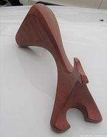 Top view of the polished teak wood abstract horse sculpture with details on the head and legs.