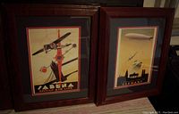 Photo of the two framed airplane advertising posters side by side, showing both the Belgian Air Line and Germany travel posters.