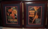 Pair of framed Hollywood pin-up movie posters including Corsair and Moon Over Miami shown side by side.