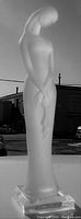 Full side view of frosted Lucite nude lady statue showing detailed body contours on clear base