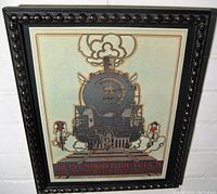Frontal photo of the Art Deco framed poster showing the steam locomotive and bicyclists.