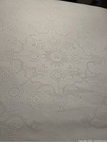 White cotton bedspread with detailed textured woven pattern featuring George Washington and traditional motifs.