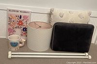 Full lot image showing the lamp shade, white picket curtain rods, llama mug, floral wall art, and two throw pillows.