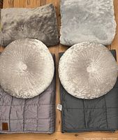 Full view of two gray weighted blankets and two round velvet textured pillow throws, laid out showing size and condition.