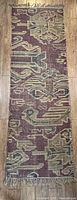 Full length photo of the jute runner rug showing overall pattern, colors, and condition.