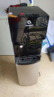 Front view of Avalon water dispenser showing logo, three water dispensing taps and drip tray