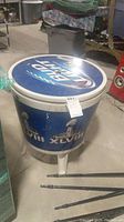 Full view of cooler showing side branding and three legs