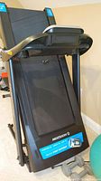 Folded treadmill deck showing the Horizon brand and Johnson Drive System sticker on the front.