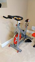 Side view showing full stationary bike including flywheel and seat