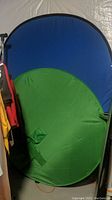 Both green and blue Zoom pop-up screens unfolded and standing upright showing their full colored surfaces.
