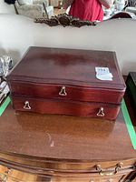 Closed two-tier wooden cutlery chest with brass hardware
