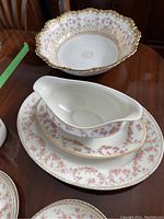 Photo of large scalloped serving bowl, gravy boat on oval serving tray showing pink rose floral and gold accents