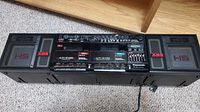 Full front view of boombox with both speakers attached, control panel and cassette decks visible