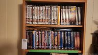 Overview of two shelves filled with DVDs showing assorted titles and box sets