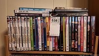 Photo showing a collection of DVDs stacked and arranged including Hopalong Cassidy, Abbott & Costello, Dean Martin roasts, and other titles.