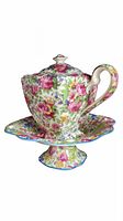 Front angle of teapot on pedestal plate showing floral pattern and scalloped edges