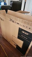 Photo of the opened box showing Acer branding and 27-inch monitor size with model series CB2