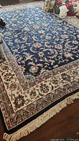 Full view of rug laid on hardwood floor showing overall design and dimensions