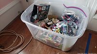 Tote box filled with assorted Lego blocks and a Lego Star Wars box on top.