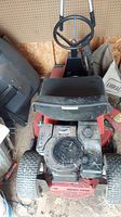 Top view showing seat, steering wheel, engine compartment of red Toro riding mower