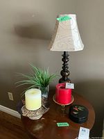 Full lot view showing lamp, candles, coaster case, and vase on wooden side table against beige wall.