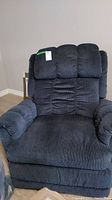 Front view of blue rocker recliner showing padded segmented backrest and armrests