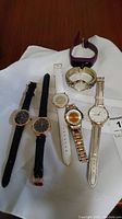 All six ladies fashion watches laid out on a white surface showing different strap and face styles
