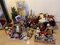 Full view of lot showing various Christmas decorations including small tree, cones, bells, figurines, and buckets.