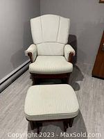 Front view of glider rocker recliner with ottoman on wood floor
