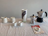 Full lot showing two Bialetti espresso makers, stacked owl cups, espresso cups, sugar bowl, milk pitcher and spare parts