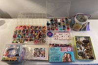 Plastic containers with beads, sequins, clay box, craft cords, rock specimens and paint-by-number kit displayed