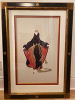 Full frontal photo of the framed print featuring the fashionable lady in black and red attire.