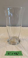 Clear glass vase 8 inches tall by 4.5 inches wide with slight flare at opening